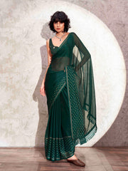 Bottle green colored satin saree with woven border and tassels on pallu with jacquard blouse