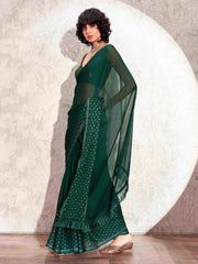 Bottle green colored satin saree with woven border and tassels on pallu with jacquard blouse