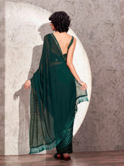 Bottle green colored satin saree with woven border and tassels on pallu with jacquard blouse
