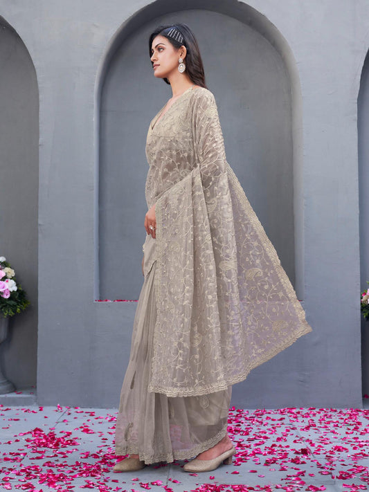 Beige colored shimmer net embroidered designer saree