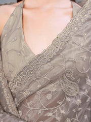 Beige colored shimmer net embroidered designer saree