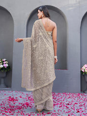 Beige colored shimmer net embroidered designer saree