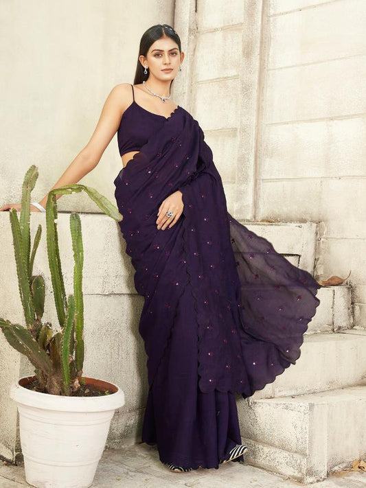 purple colored saree with mirror embroidery on pallu and scalloped border