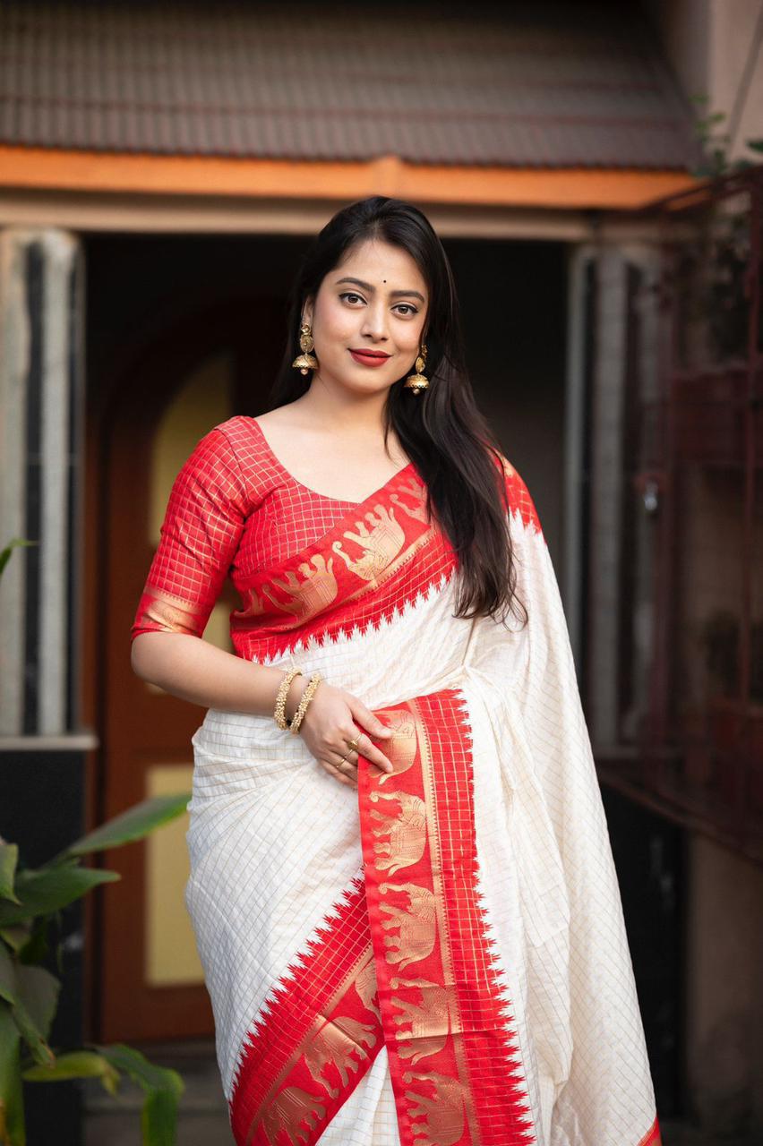 sift silk saree with zari woven chex and with elephant border and rich pallu.Cotton tasslels on pallu.