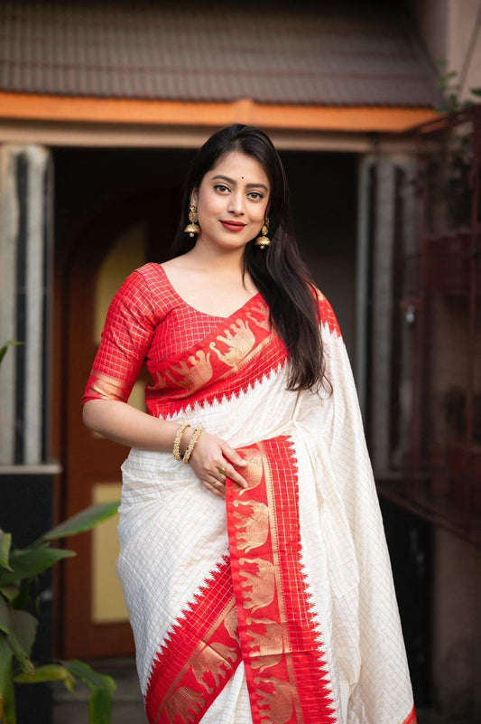 sift silk saree with zari woven chex and with elephant border and rich pallu.Cotton tasslels on pallu.