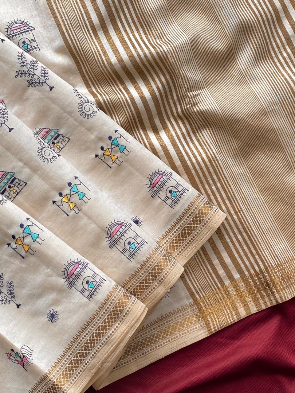 PURE LOOM TUSSAR SAREE WITH ALL OVER WORLI EMBROIDERY PATTERN,  COPPER ZARI BORDER AND ZARI WOVEN PALLU.