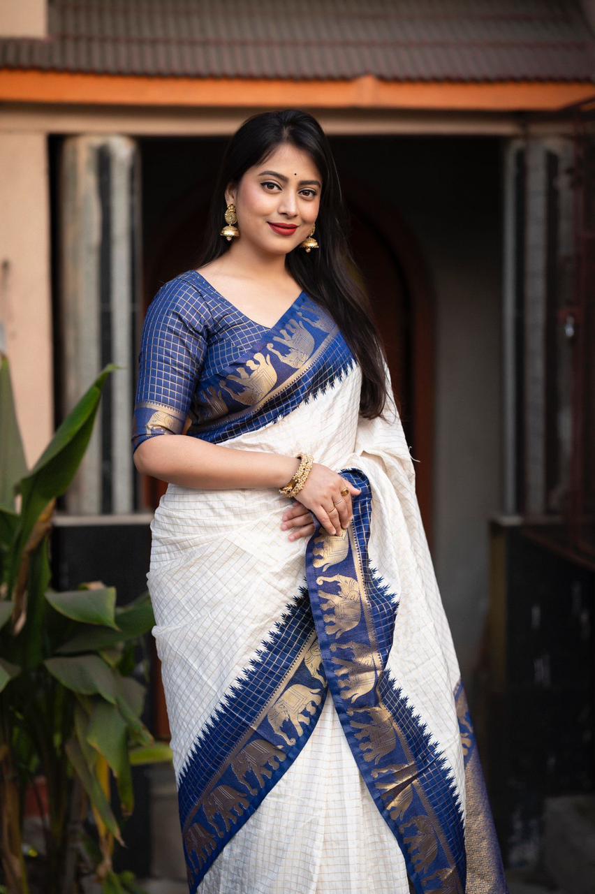 sift silk saree with zari woven chex and with elephant border and rich pallu.Cotton tasslels on pallu.