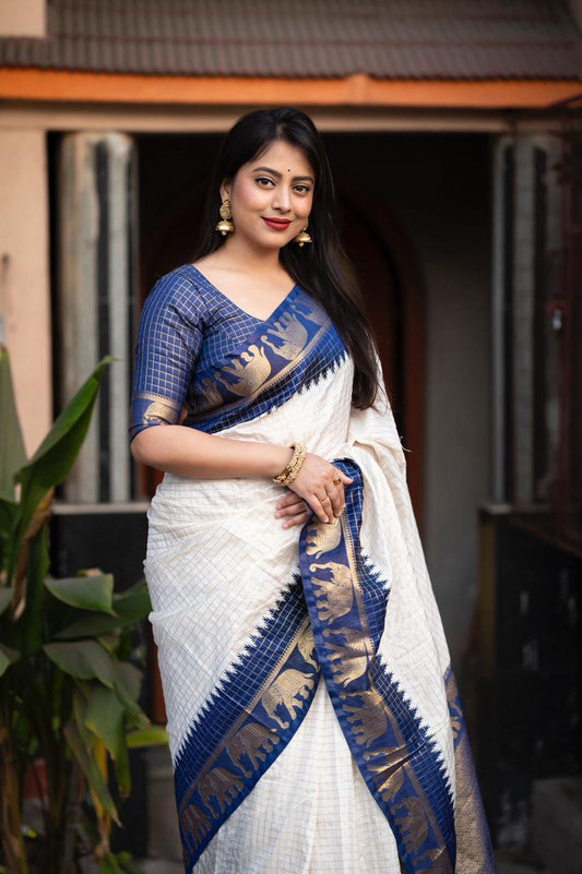 sift silk saree with zari woven chex and with elephant border and rich pallu.Cotton tasslels on pallu.