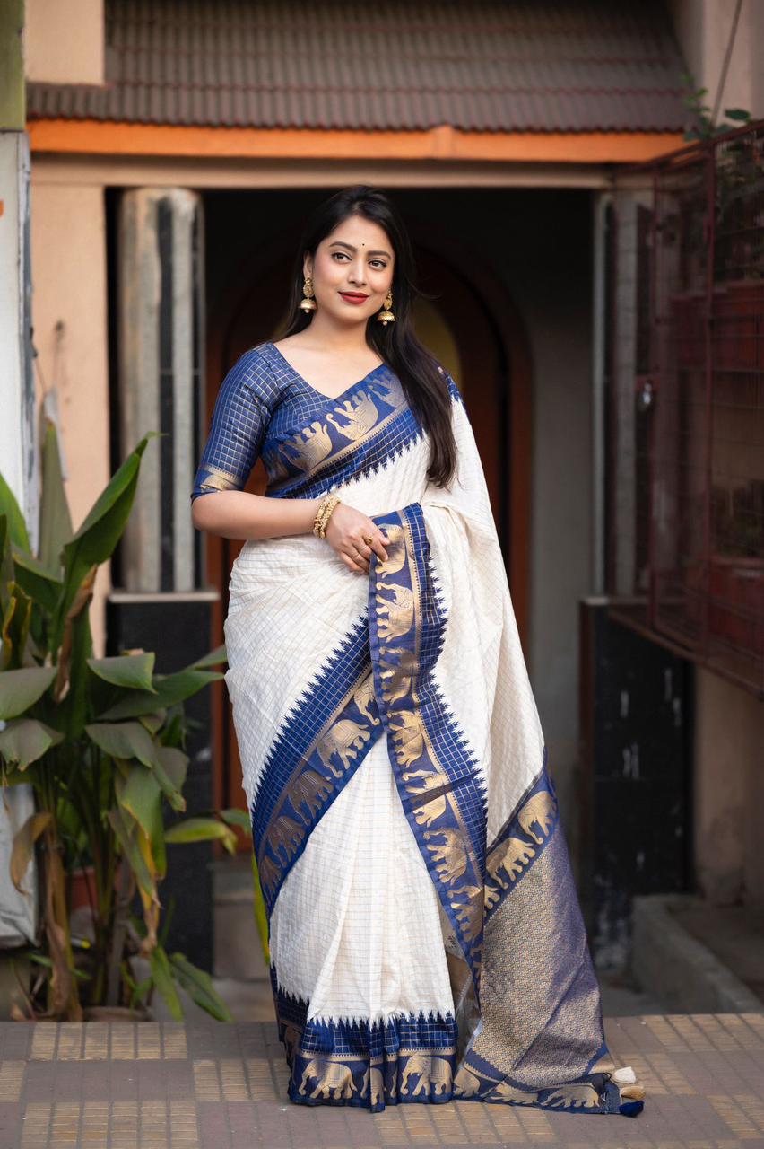 sift silk saree with zari woven chex and with elephant border and rich pallu.Cotton tasslels on pallu.