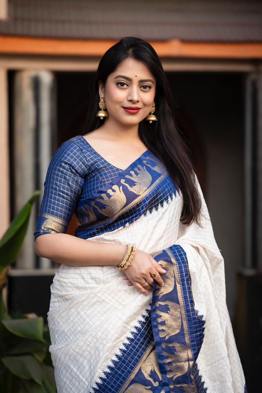 sift silk saree with zari woven chex and with elephant border and rich pallu.Cotton tasslels on pallu.